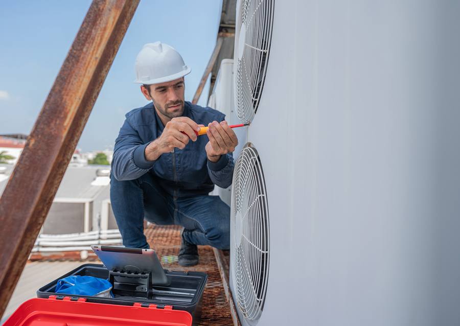 HVAC technician servicing air conditioning unit in Norwalk, CA